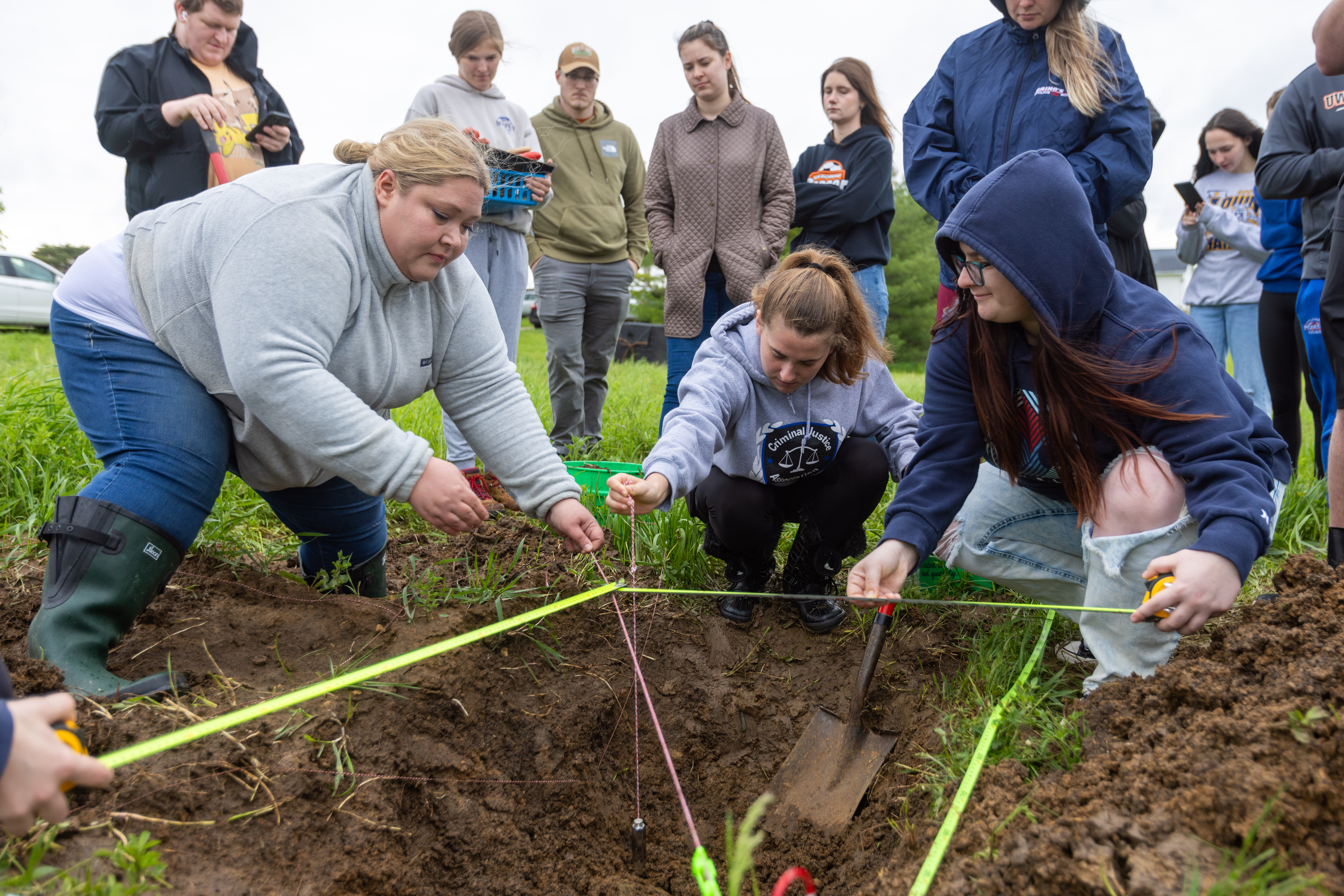 Forensic anthropologist Dr. Janamarie Truesdell working with students at the Forensic Investigation Research Facility, a 1.5-acre fenced area designed for practical training and research.