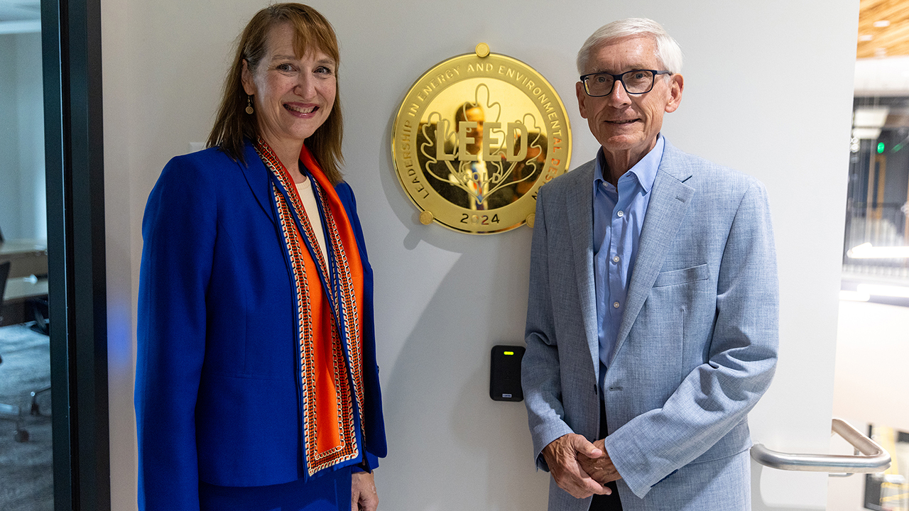 Chancellor Evetovich shares with Governor Evers news of Sesquicentennial Hall's LEED Gold certification.