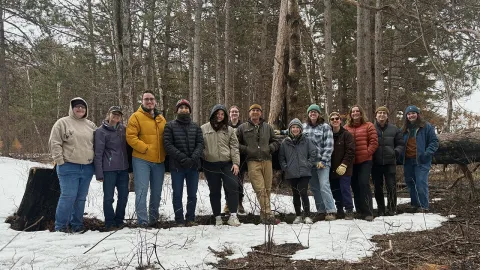 Group of UW-Platteville students in forest, standing in front of trees
