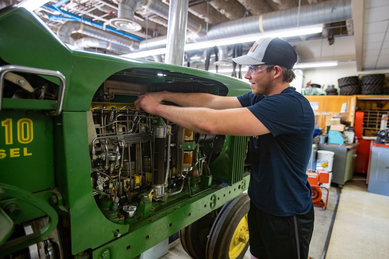 Student working on tractor