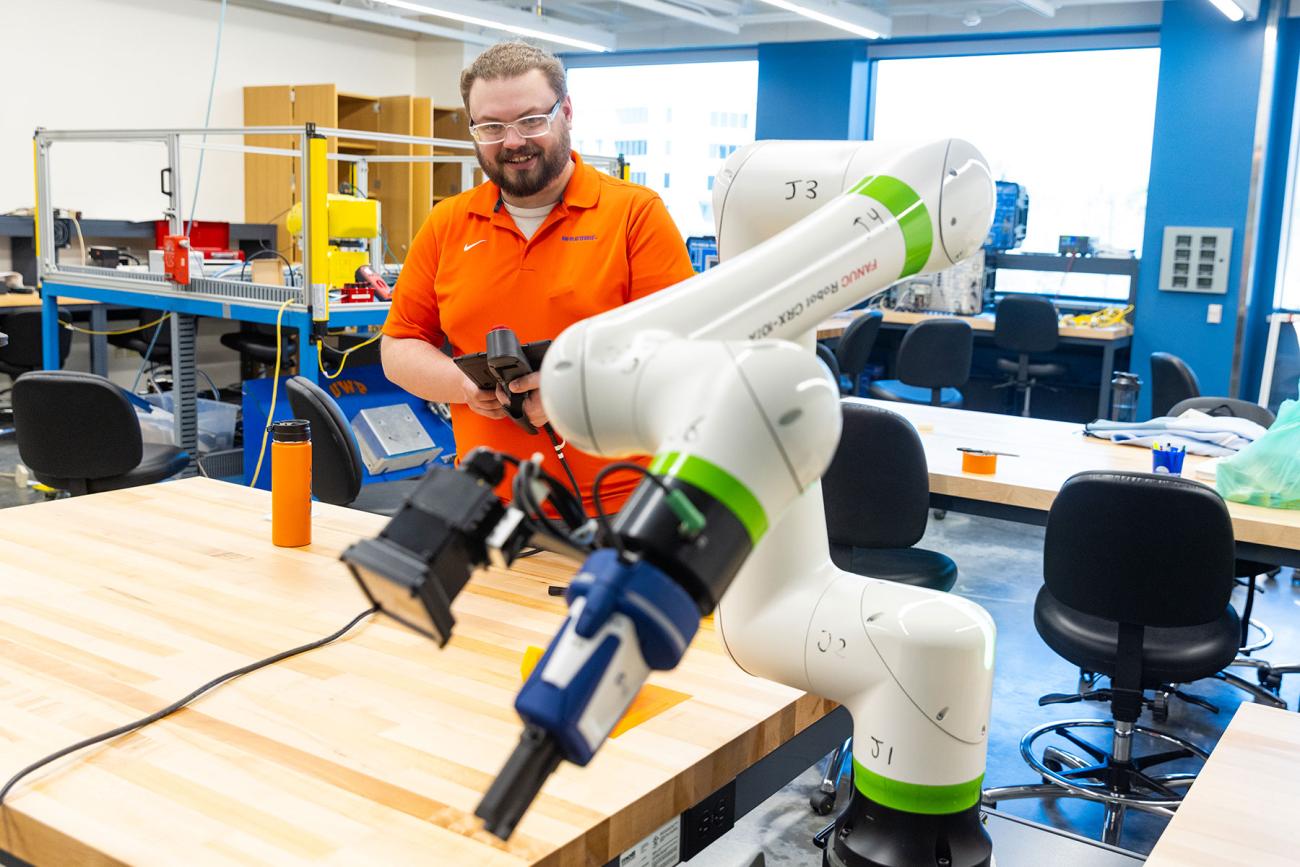 instructor and professor working with students in iiot testbed