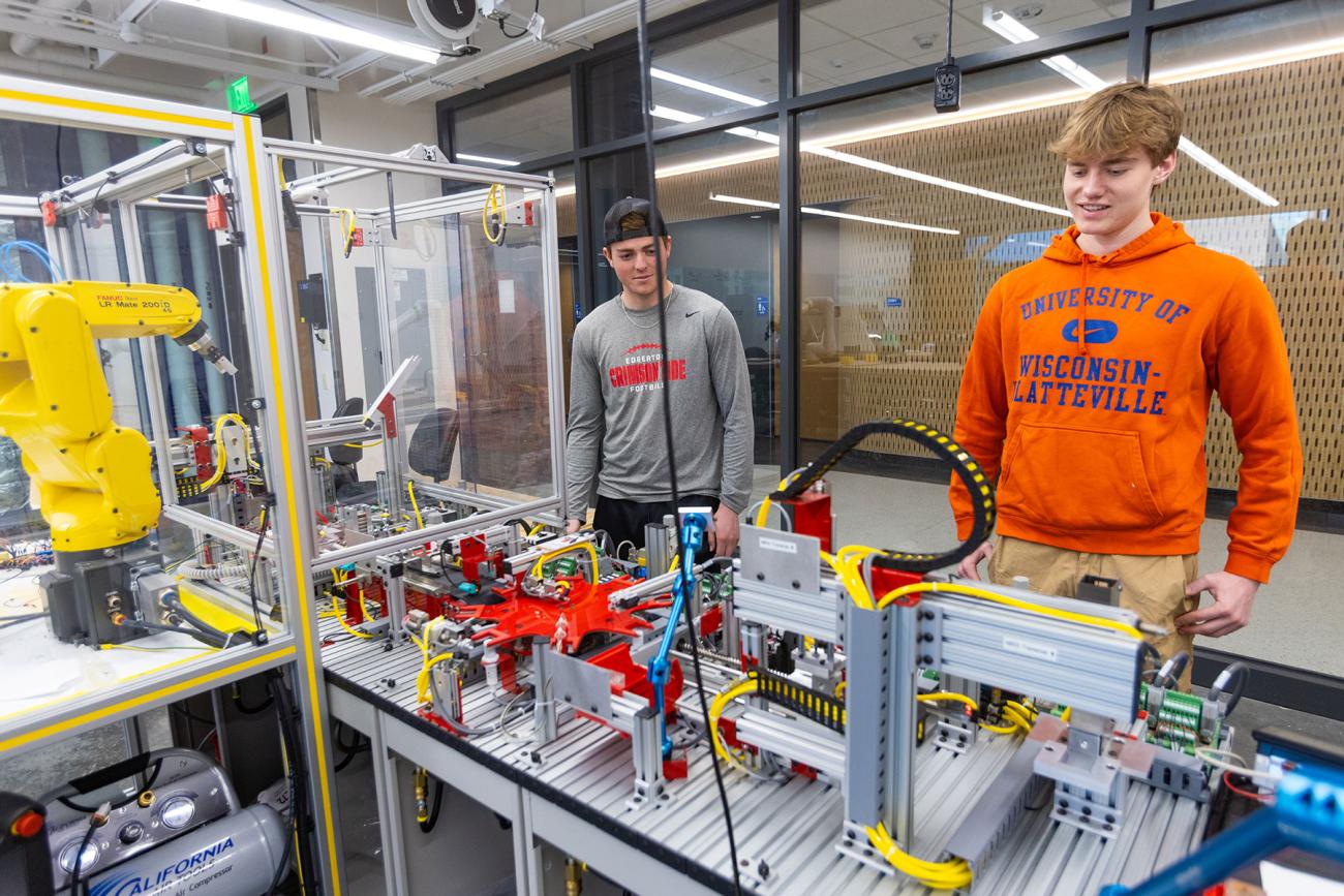 instructor and professor working with students in iiot testbed