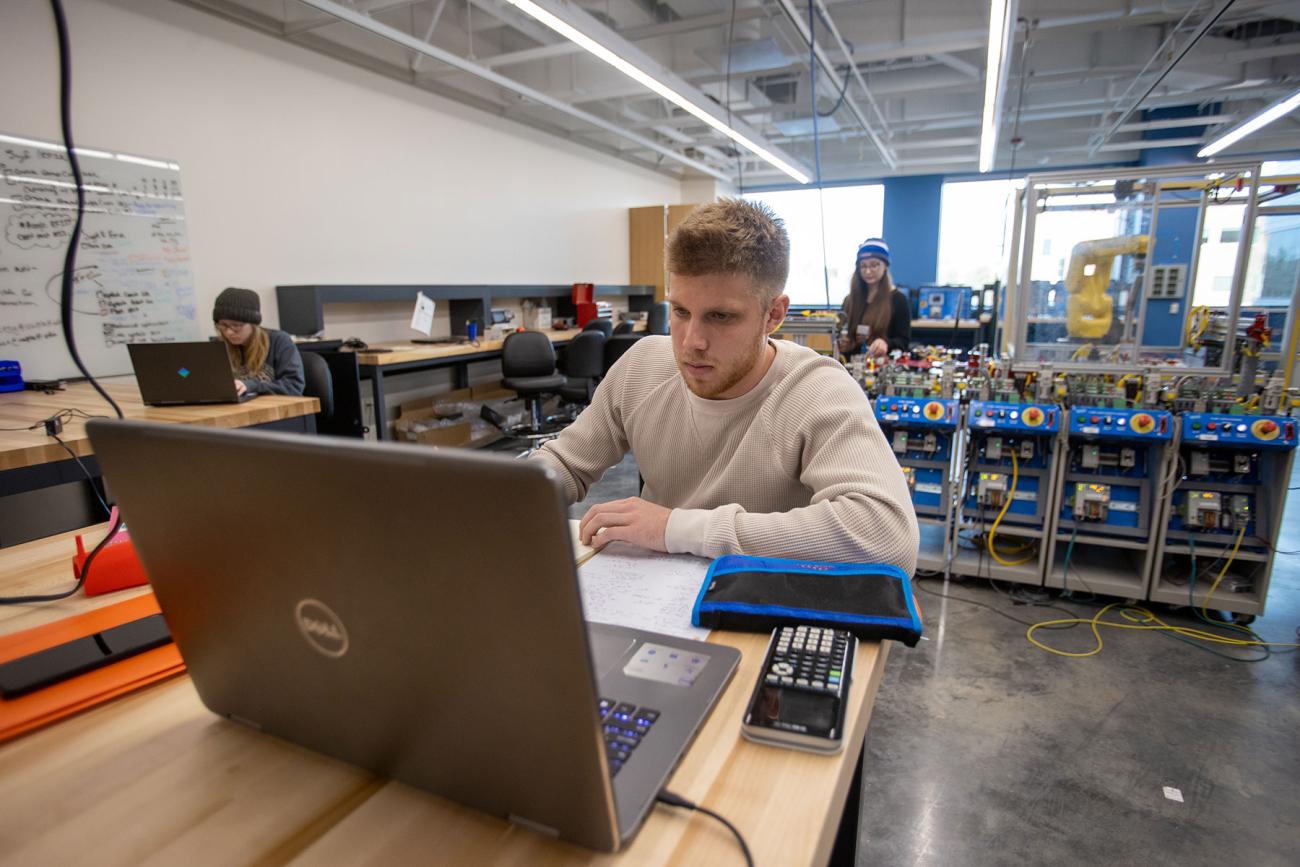 instructor and professor working with students in iiot testbed