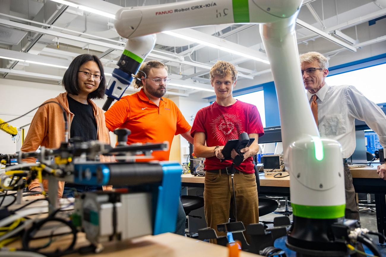 instructor and professor working with students in iiot testbed