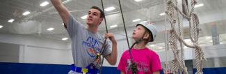 Student instructing on ropes course 