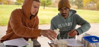 Two students doing science