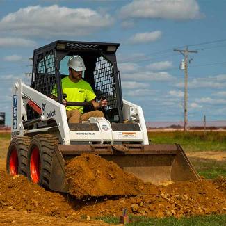 Student using skid steer