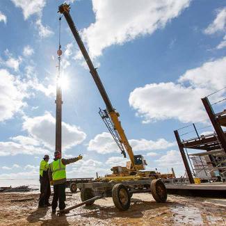 students working with Grove Rough Terrain Crane