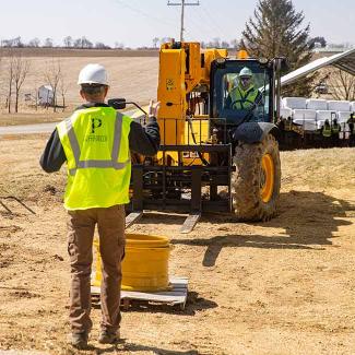 Student operating telehandler