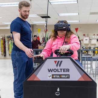 Student operating forklift simulator