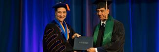 Chancellor handing over diploma 