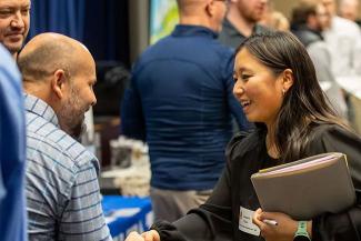 Student shaking hands with employer at the Career Fair