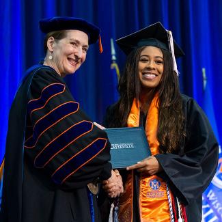 Chancellor with student at commencement