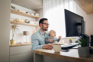 father studying with baby in lap