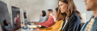 woman sitting at computer coding