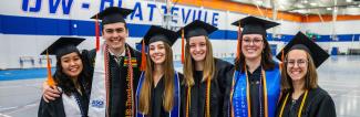 Group of 7 graduates smiling