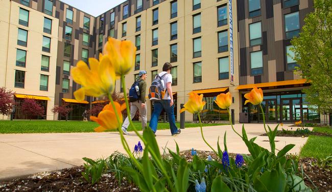 Exterior photo of UW-Platteville dormitory with flowers and grass in foreground